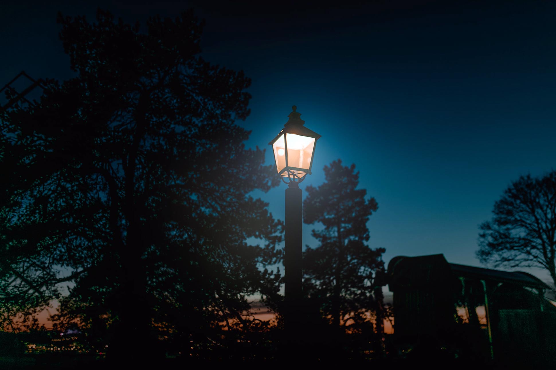 A lantern burns at dusk in Royal Djurgården during Halloween in Stockholm, Sweden