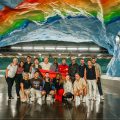 Our pride party under a rainbow mural at Stadion Station.