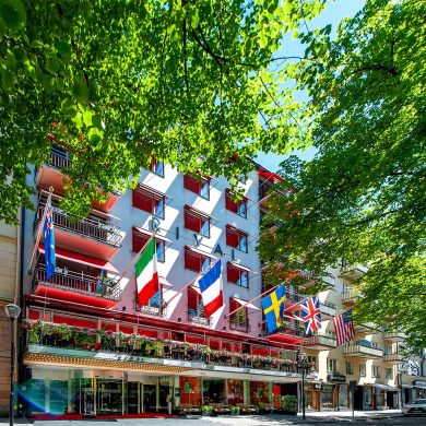 Exterior of Hotel Rival on Mariatorget in Södermalm, Stockholm, an LGBTQ+ welcoming boutique hotel with international flags flying above its entrance