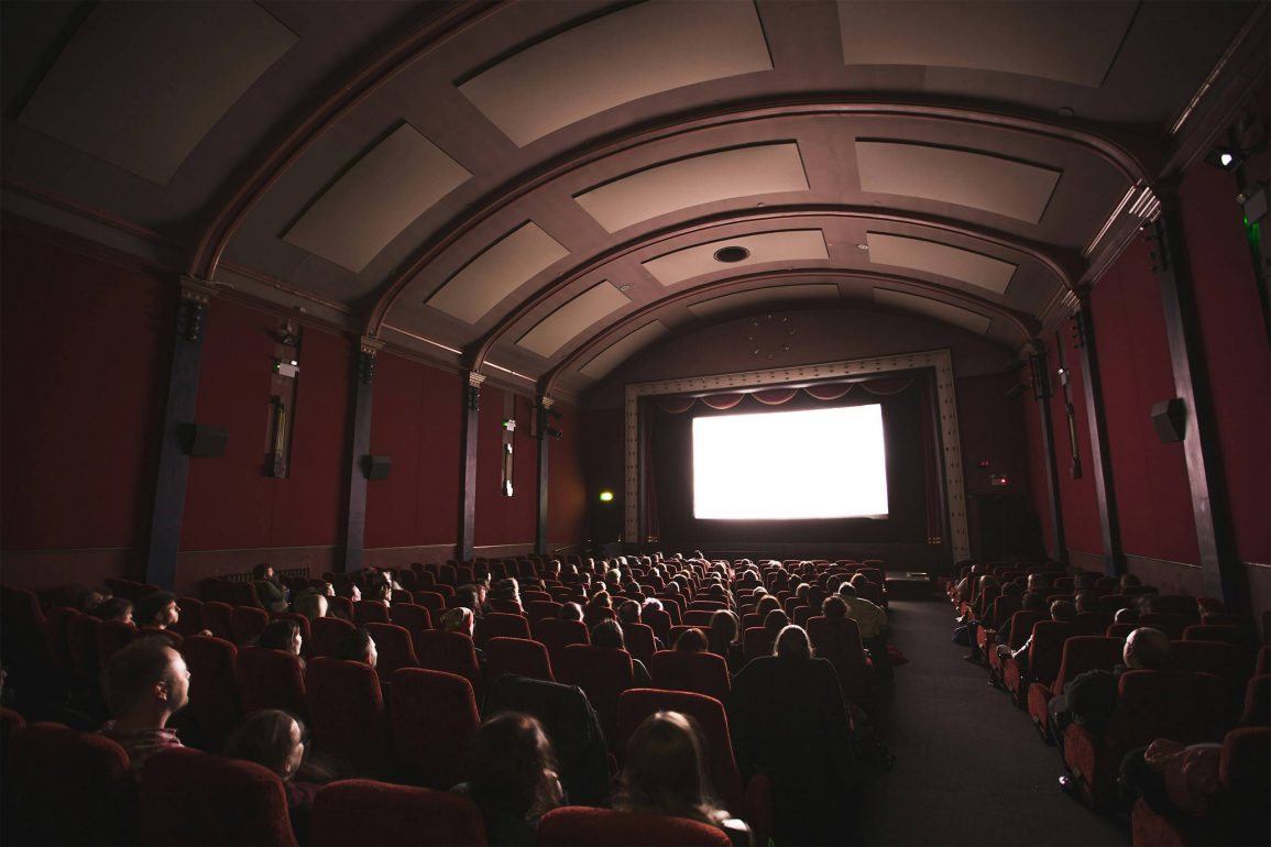 A dimly lit cinema screening during Cinema Queer in Stockholm.