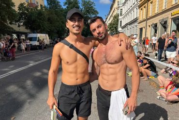 Two shirtless gay travellers at the Stockholm Pride parade.