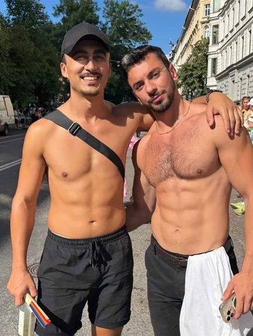 Two shirtless gay travellers at the Stockholm Pride parade.
