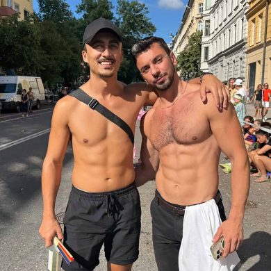 Two shirtless gay travellers at the Stockholm Pride parade.
