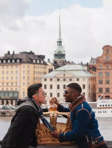 Two gay men kiss by the waterfront in Stockholm