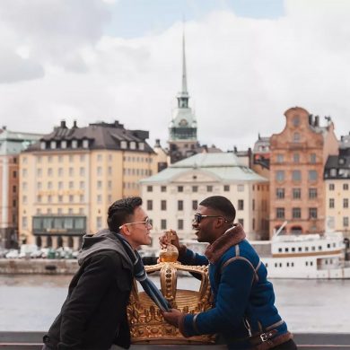 Two gay men kiss by the waterfront in Stockholm